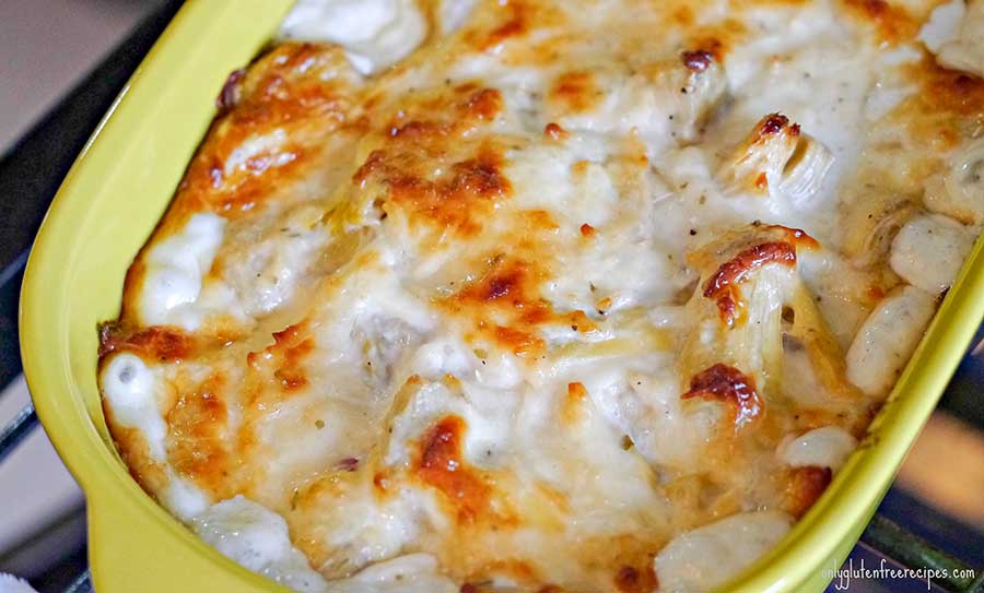 hot artichoke dip in a small casserole dish