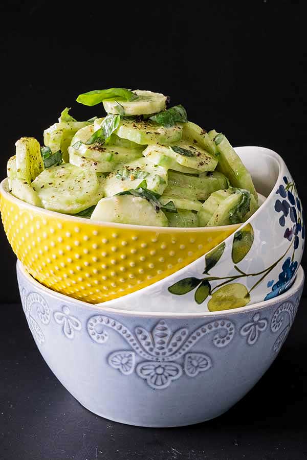 German cucumber salad in 3 stacked bowls