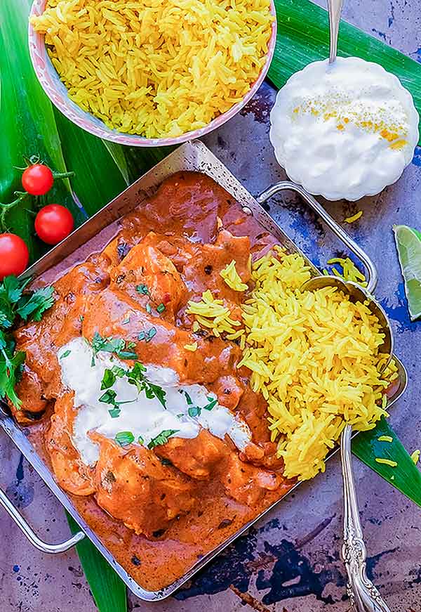 Indian butter chicken with rice in a pan