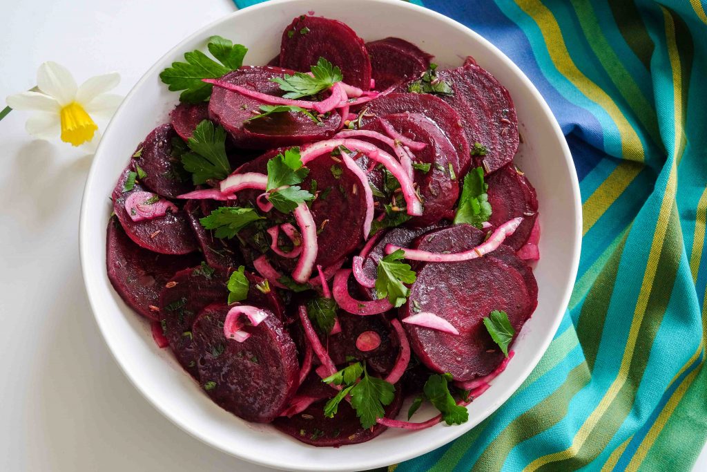 beets, onions, herbs and a light vinaigrette in a bowl