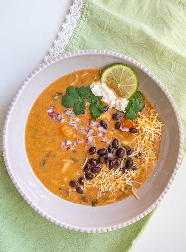 vegetarian tortilla soup in a bowl topped with lime slices