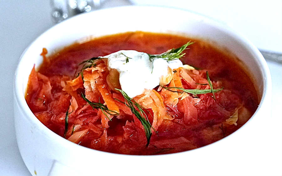 Ukrainian borscht in a bowl topped with sour cream