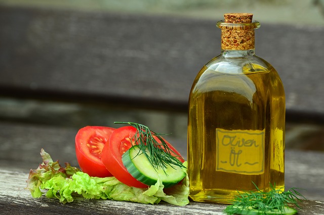 sliced tomato, basil, olive oil for salad dressing