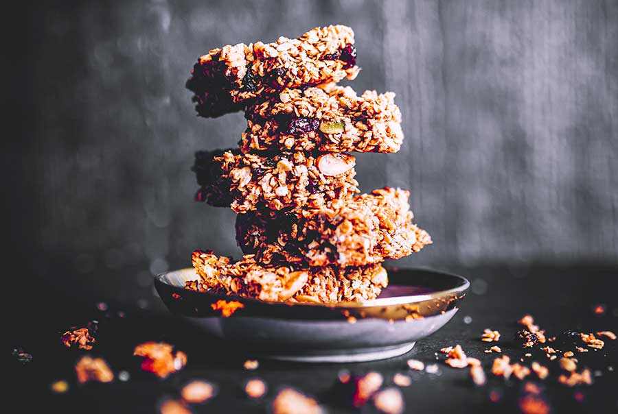 protein bars on a plate with scattered seeds on the table