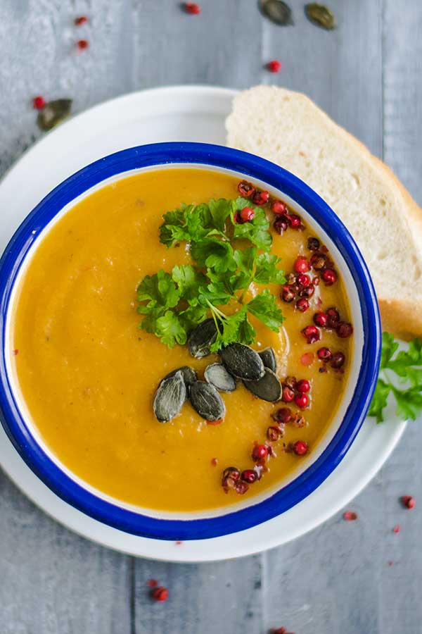 top view of thai carrot soup with toppings