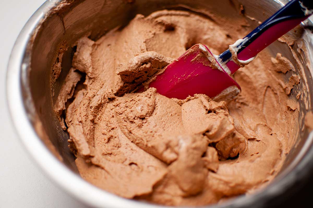 chocolate mousse mixture in a bowl with a spatula
