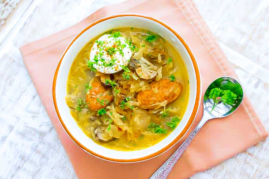 overview of sauerkraut soup with sour cream in a bowl