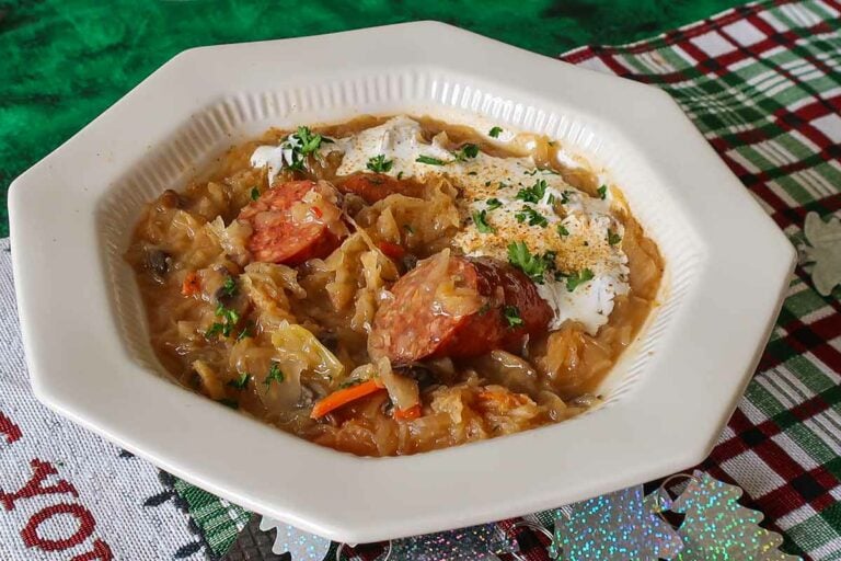 sauerkraut soup topped with yogurt in a bowl