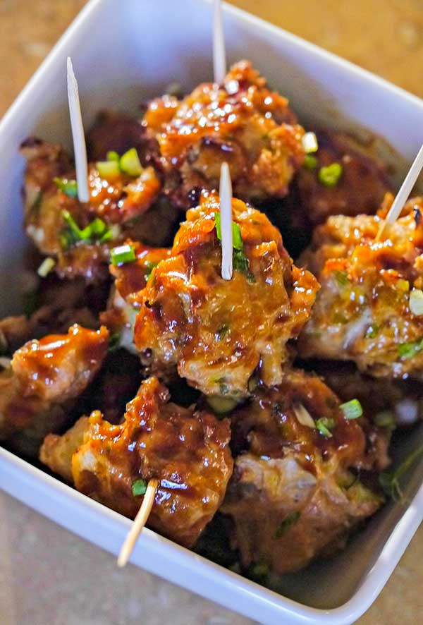 Asian meatballs in a bowl with toothpicks