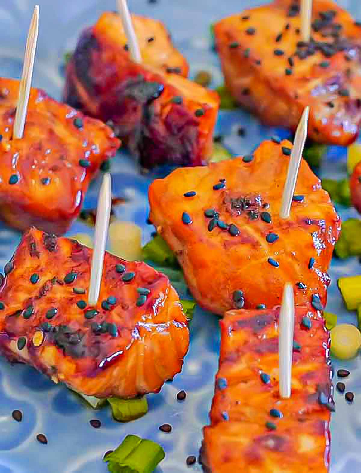 tamari and honey salmon suckers appetizer on a plate with toothpicks