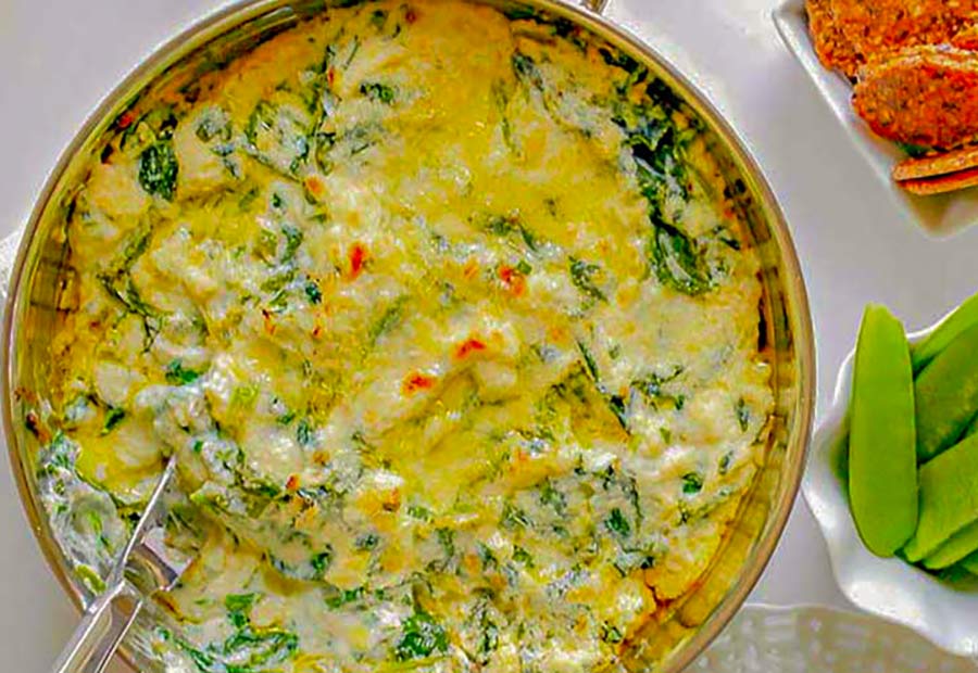bubbling creamy spinach and ricotta flavoured dip in a bowl