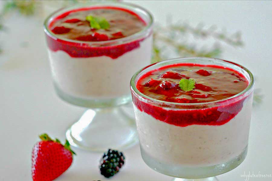 strawberry ricotta mousse in glass cups topped with strawberry sauce