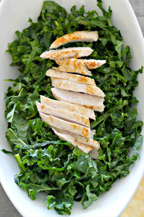 kale salad topped with chicken, leafy greens recipes