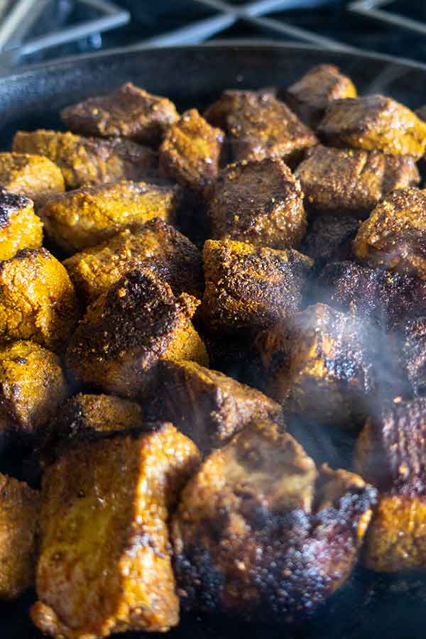 searing beef in a cast iron skillet