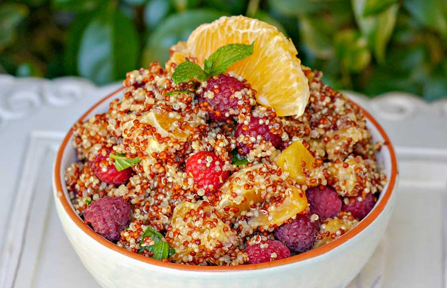 summer quinoa fruit salad with oranges in a bowl