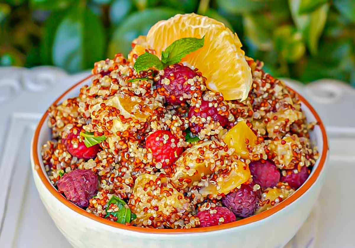 quinoa fruit salad in a bowl garnished with mint