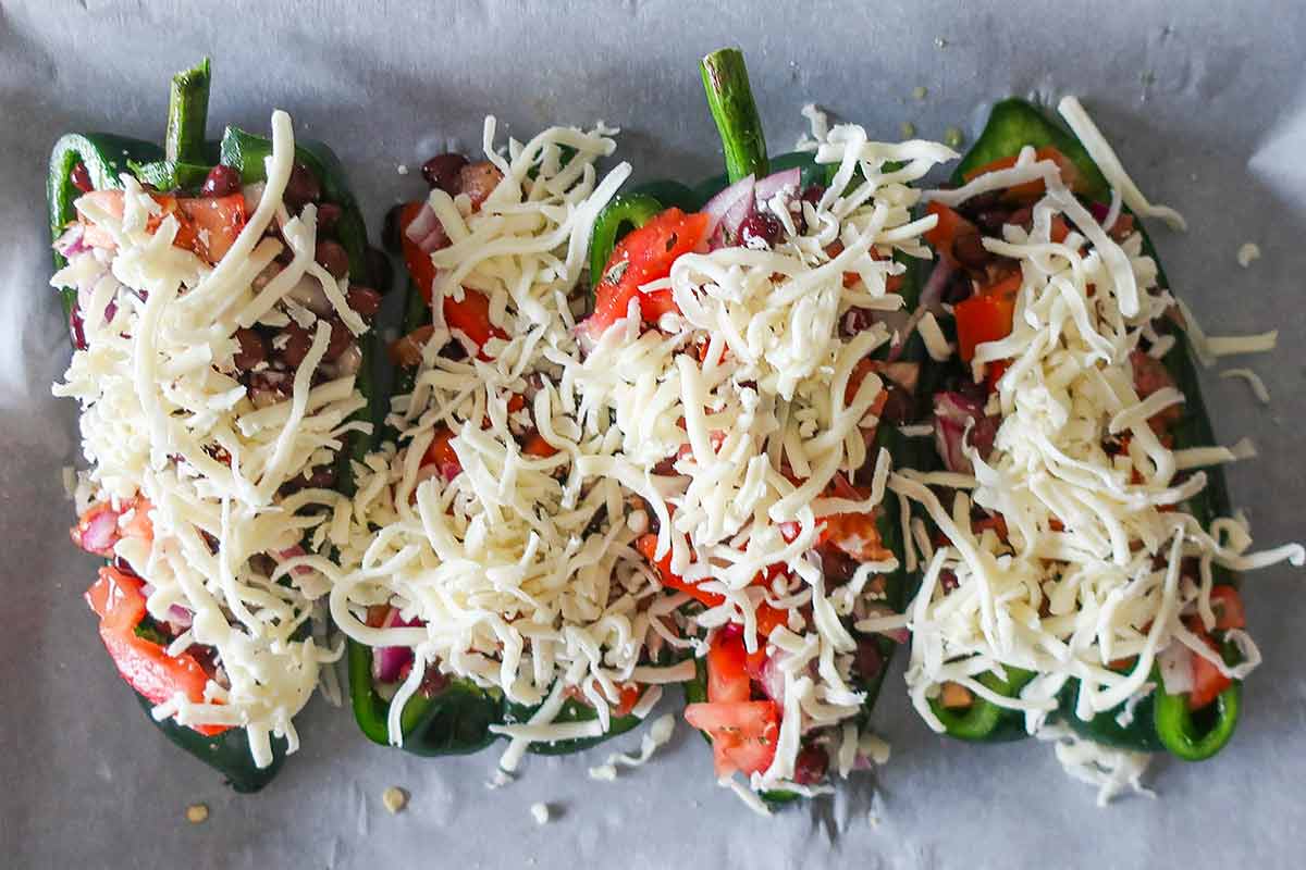 shredded cheese topping on poblano peppers