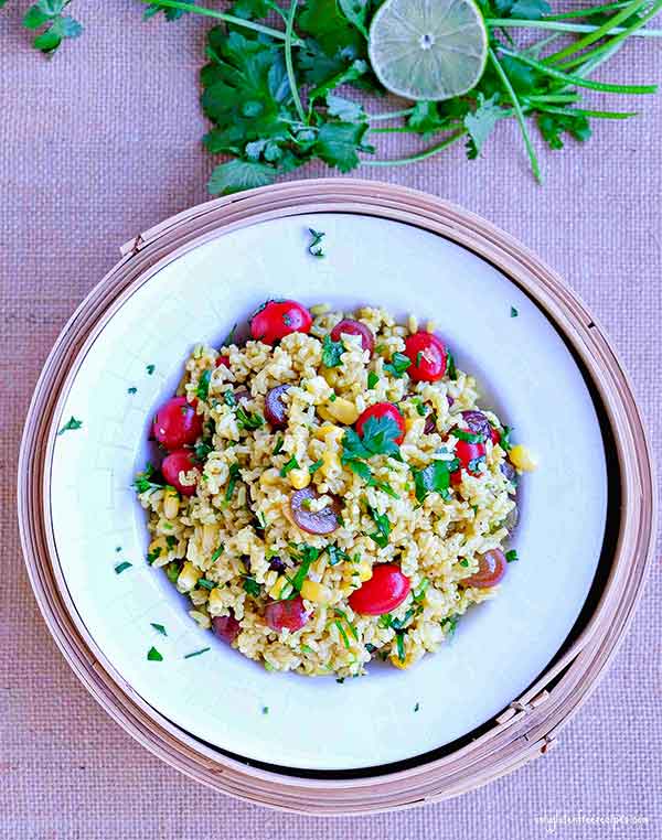 curried rice salad with corn, tomatoes and grapes
