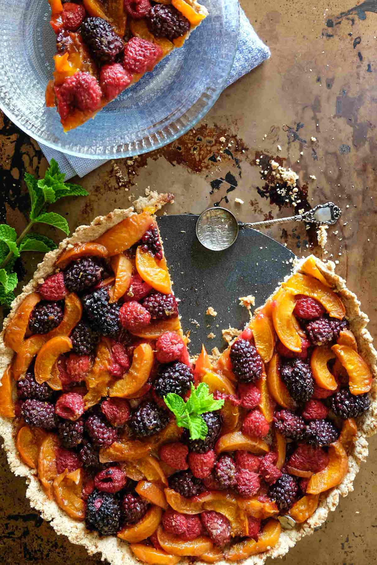 gluten free fruit tart with a slice on a plate