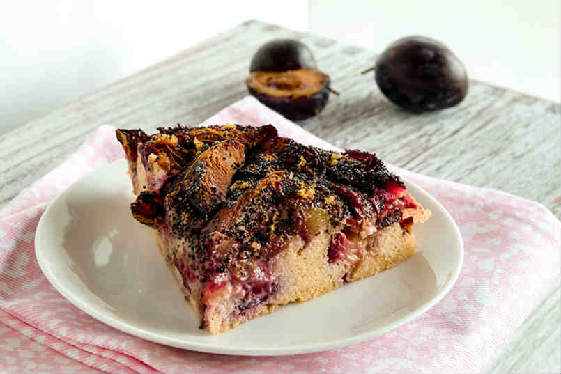 slice of plums skillet cake on a plate