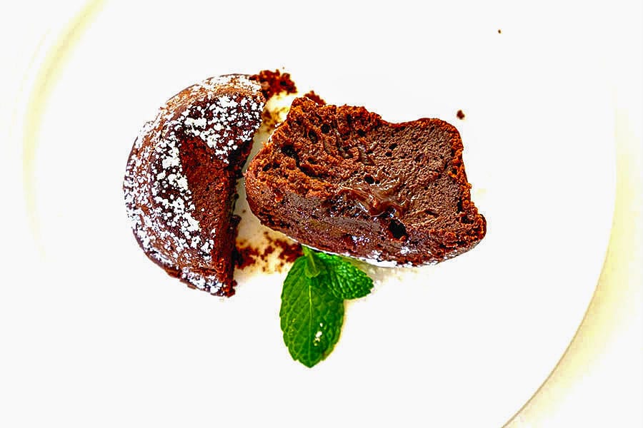 halved chocolate lava muffin on a plate