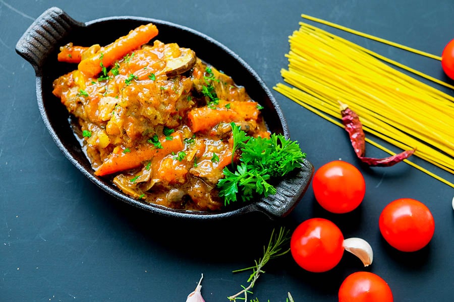 chicken cacciatore with veggies in a delicious light tomato sauce in a cast iron skillet