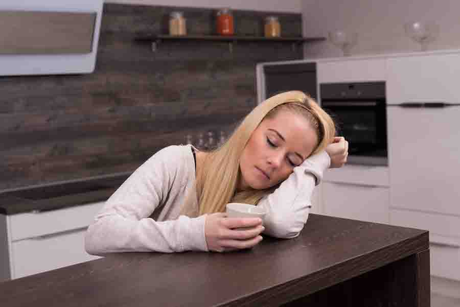 woman sleeping on top of her desk