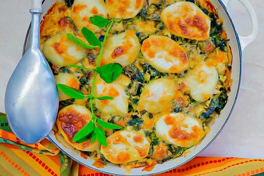 Moroccan lamb potato spinach casserole in a skillet