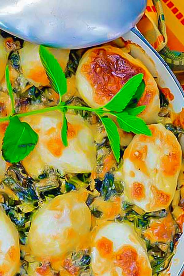 baked lamb cheese collards in a skillet