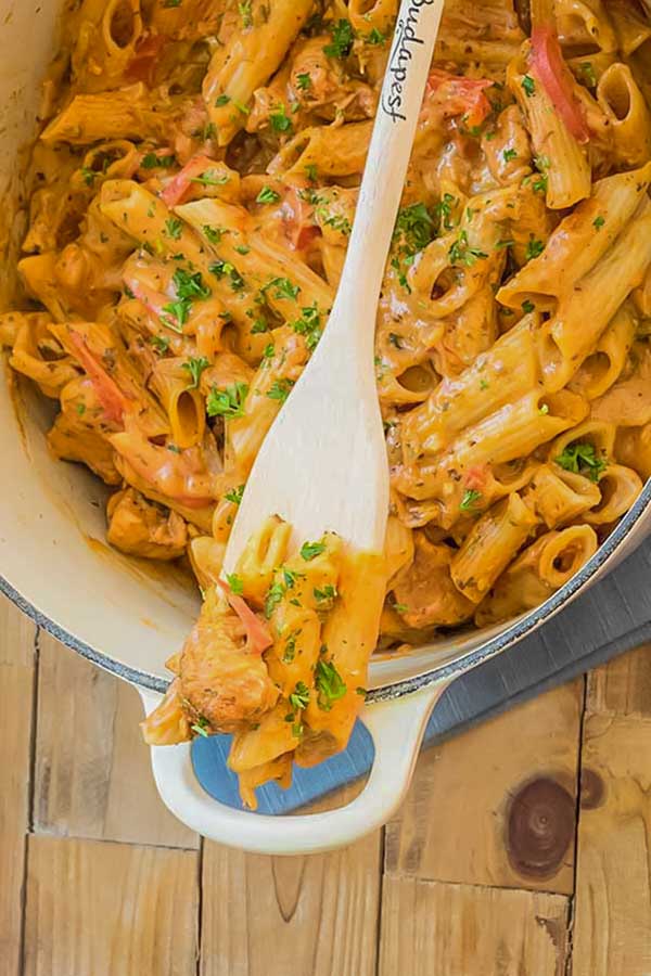 chicken paprikash pasta in a pot with wooden fork, gluten-free