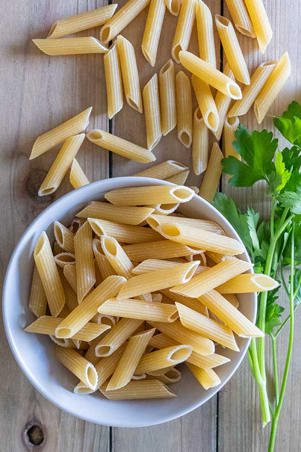 gluten-free dry penne pasta in a bowl