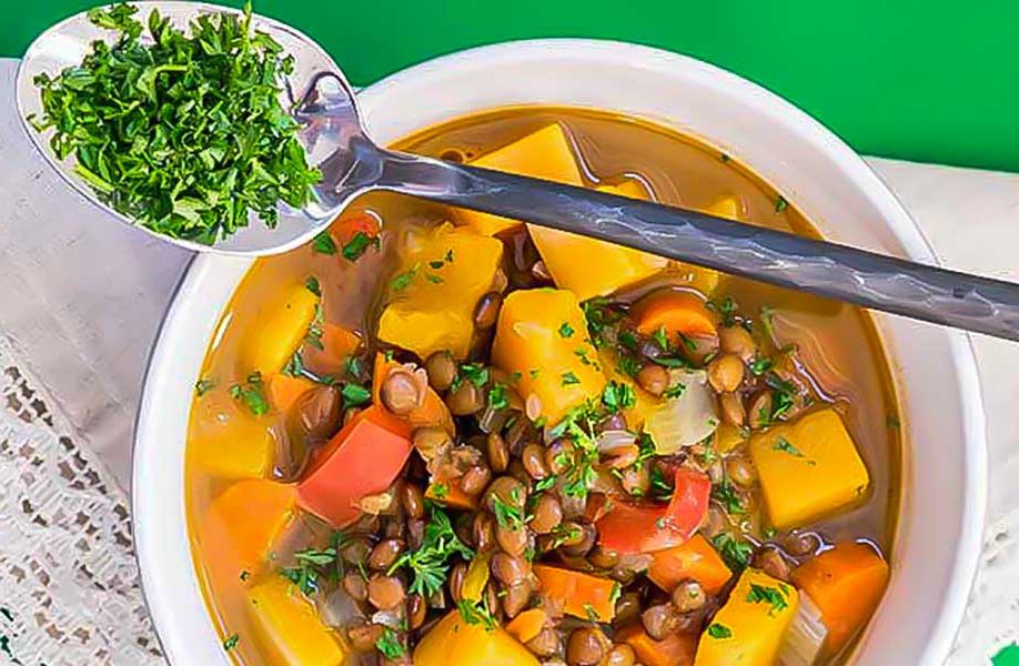 lentil butternut squash soup in a bowl with a spoon, vegan