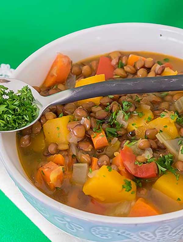 vegan soup with vegetables in a bowl with a spoon