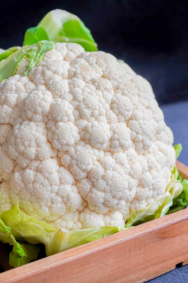 raw cauliflower head on a tray