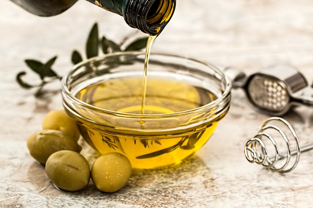 olive oil in a bowl with olives on the side