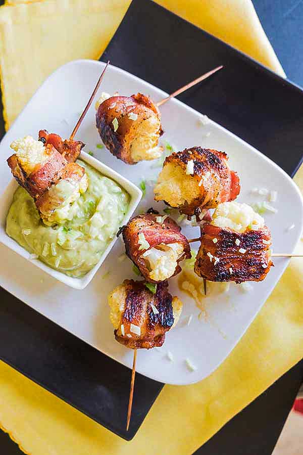roasted bacon wrapped cauliflower with a dip