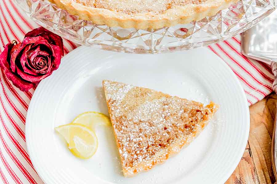 a slice of lemon tart on a plate, gluten free