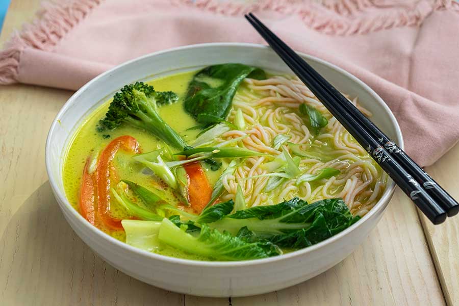 vegan coconut curry ramen in a bowl with chopsticks