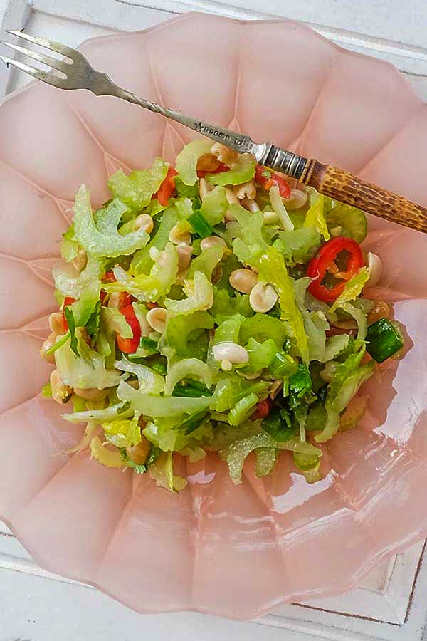 thai celery and fennel salad in a bowl with a fork