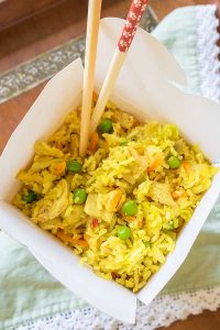 curry pork fried rice in a paper box with chopsticks