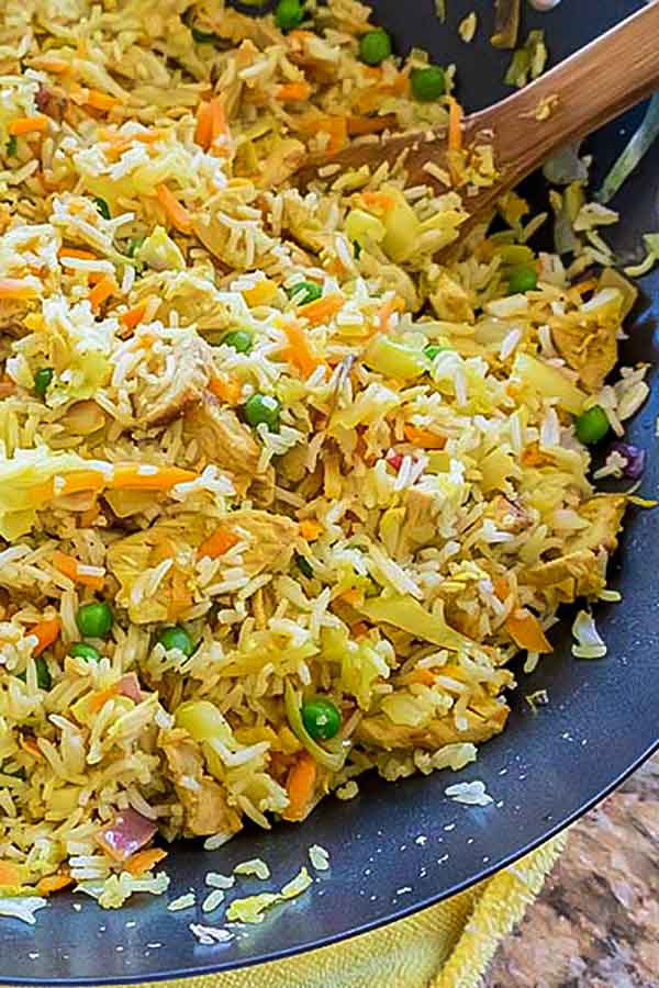 curry pork fried rice dish in a wok