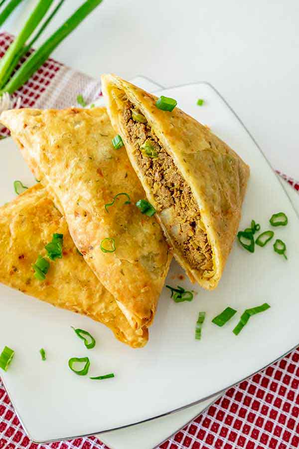 3 gluten free beef samosas on a small plate