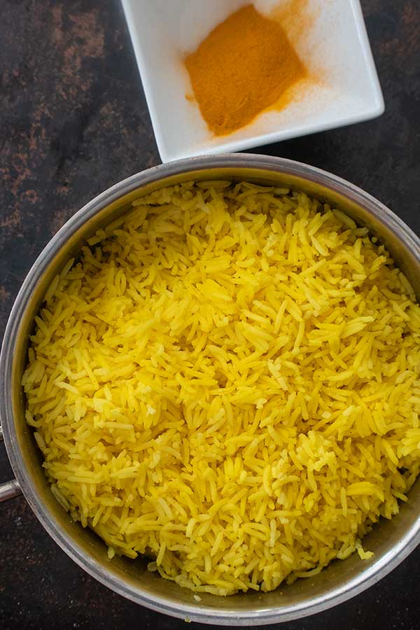 cooked rice with turmeric in a saucepan