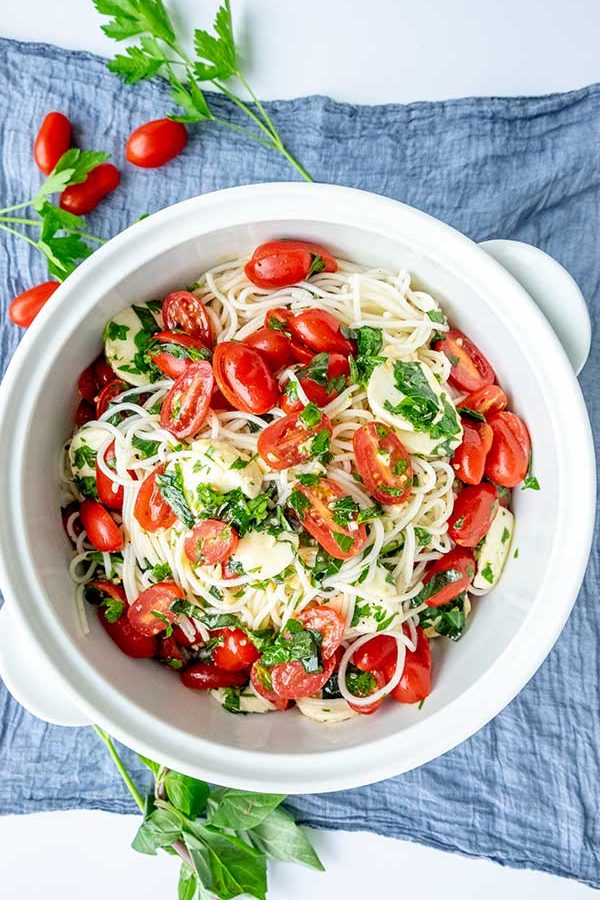 italian pasta salad with cherry tomatoes and basil in a bowl, gluten free