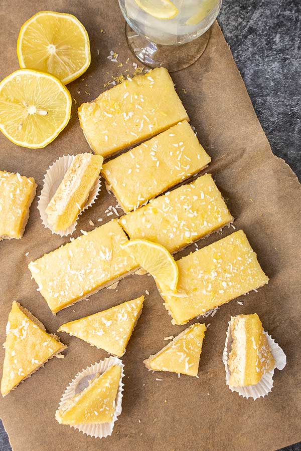 various sizes of lemon coconut bars on parchment paper