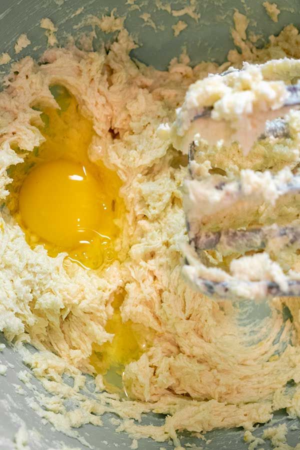 mixing an egg in lemon loaf batter