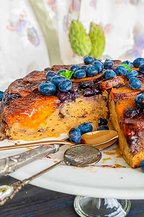 half a tarte tatin cake on a platter with spoons