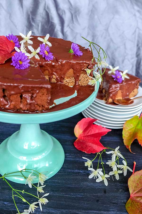 chocolate pumpkin cake with ganache topping on a cake stand