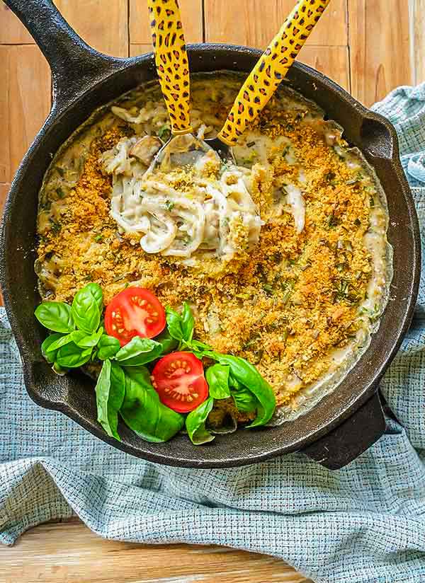 creamy pasta with zucchini and mushrooms in a skillet, vegan, gluten free