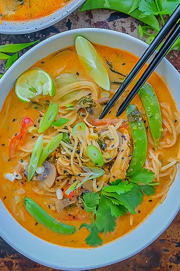 Thai chicken ramen in a bowl with chopsticks